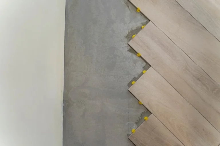 Luxury vinyl plank laid up to a wall with spacers holding the expansion gap open