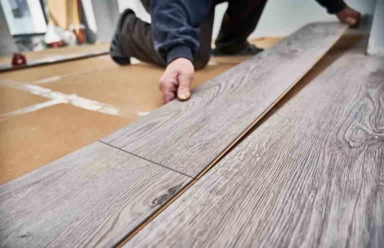 Close-up of a plank being clicked into the previous row during an LVP installation