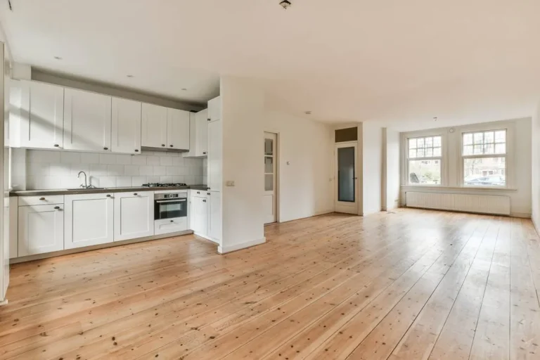Open-plan kitchen and living area with a light wood-look plank floor running throughout