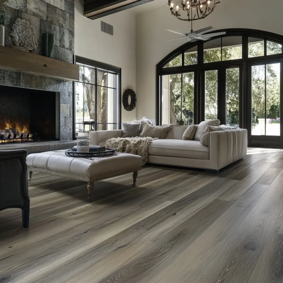 Living room with wide grey wood-look plank flooring running to the fireplace
