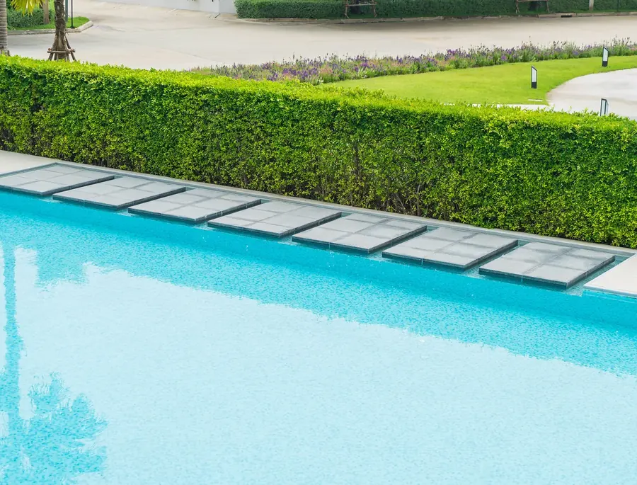 Pool edge with stone slabs set flush along the coping